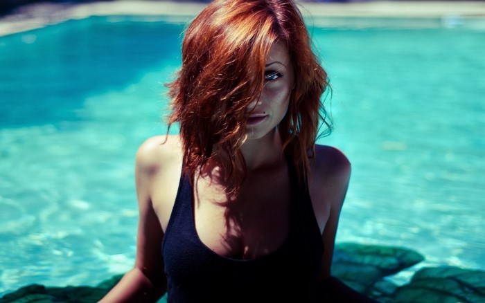 Woman with red hair in a swimming pool