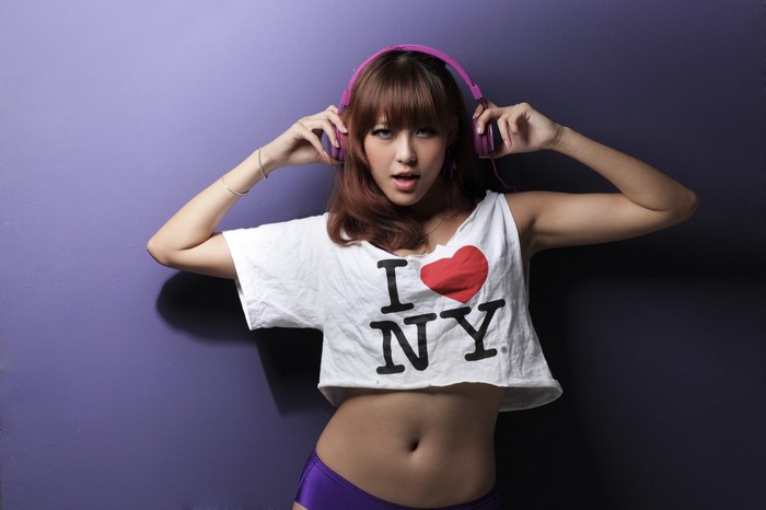 Woman wearing headphones and I Love NY shirt