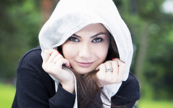 Woman wearing a hooded sweater, outdoors