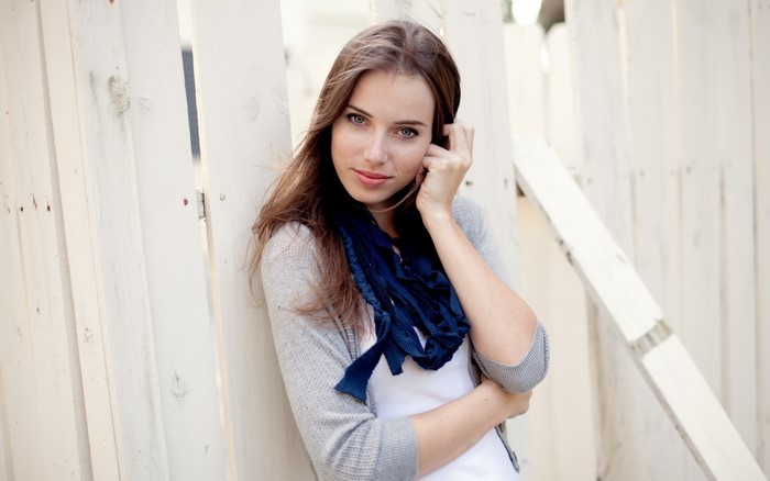 Woman with long brown hair and blue scarf
