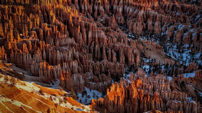Sunlit Rock Formations and Snowy Canyon in Utah