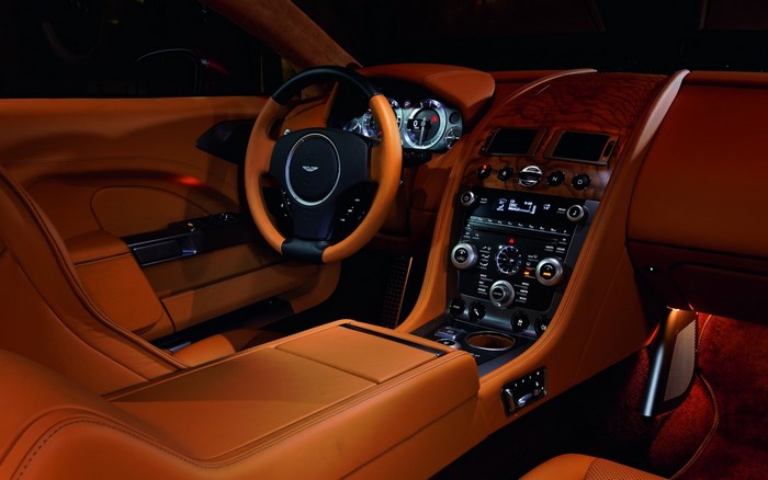 Aston Martin interior with orange leather and wood trim