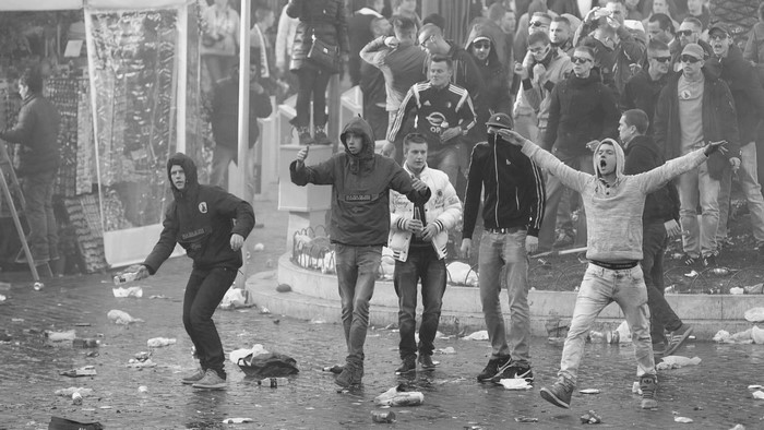 Monochrome photograph of a crowd during a riot