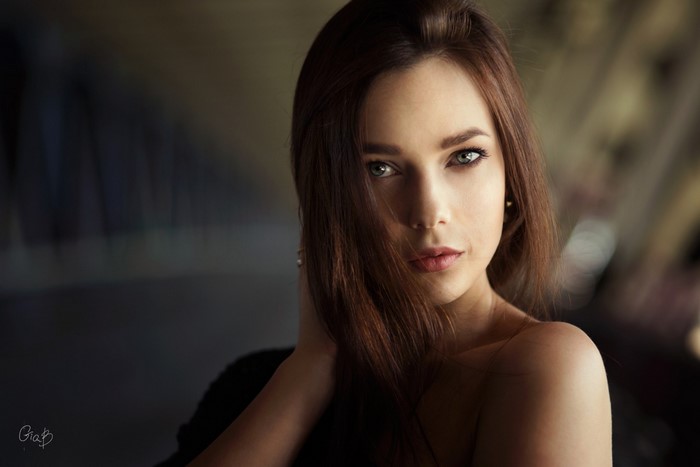 Woman with auburn hair looking at viewer
