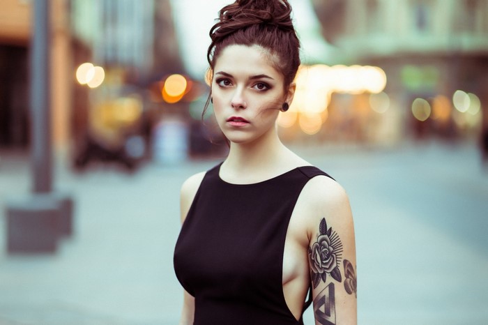 Woman with tattoo in black dress