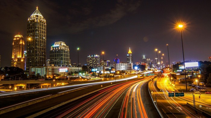 Atlanta cityscape at night with light trails on highway
