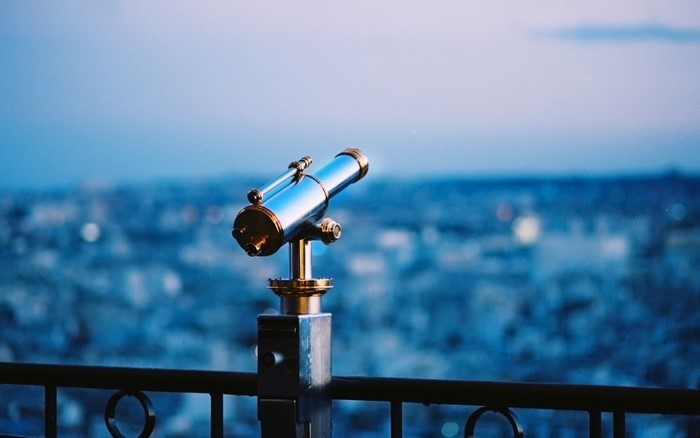Telescope overlooking a city at dusk