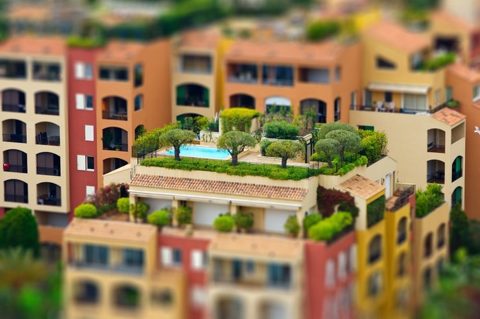 Colorful buildings with rooftop swimming pool and trees