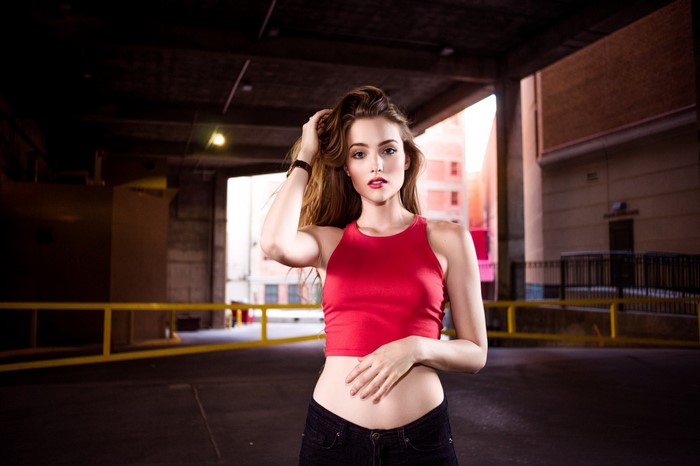 Model in red tank top and black jeans