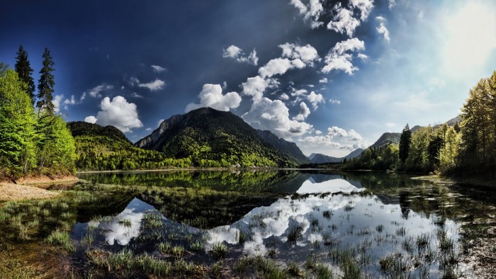 Mountain lake with reflections and clouds