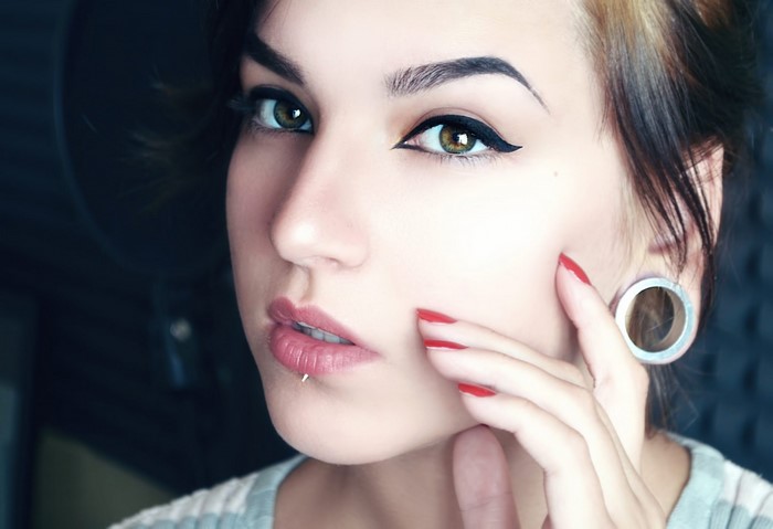 Close-up Portrait of Woman with Pierced Lip and Makeup