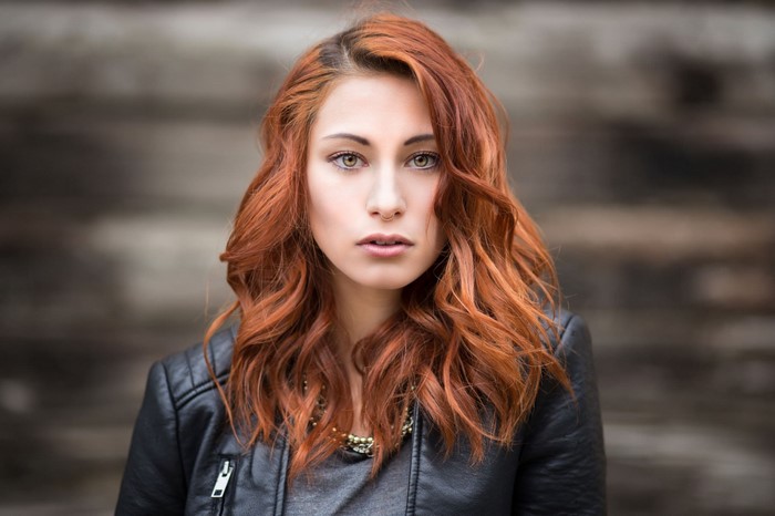 Woman with red hair wearing a leather jacket