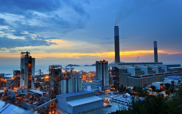 Industrial power plant at sunset by the sea