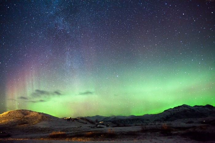 Northern Lights over Iceland landscape with stars