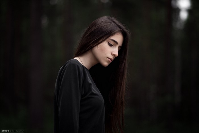 Woman with long brown hair in black shirt