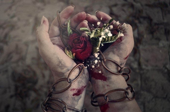 Hands chained with a rose and flowers