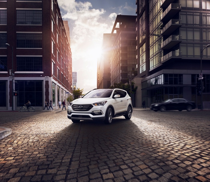 White Hyundai Santa Fe Sport on a cobblestone street