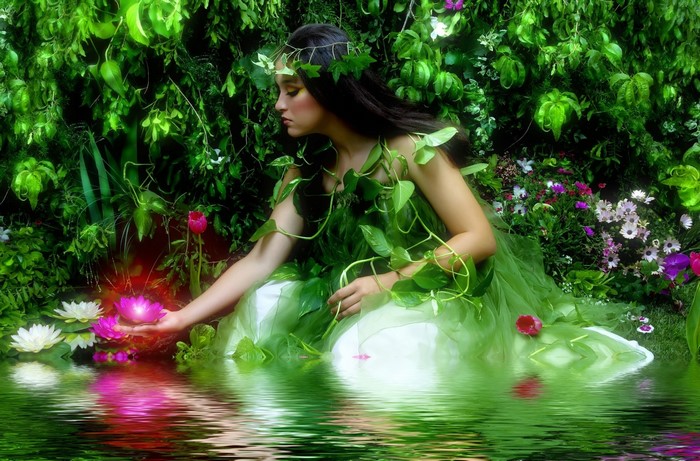 Woman in a green dress with vines in a garden