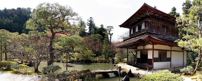 Japanese temple building in a garden with a pond