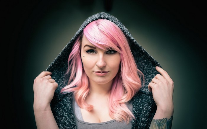 Woman with pink hair wearing a hoodie
