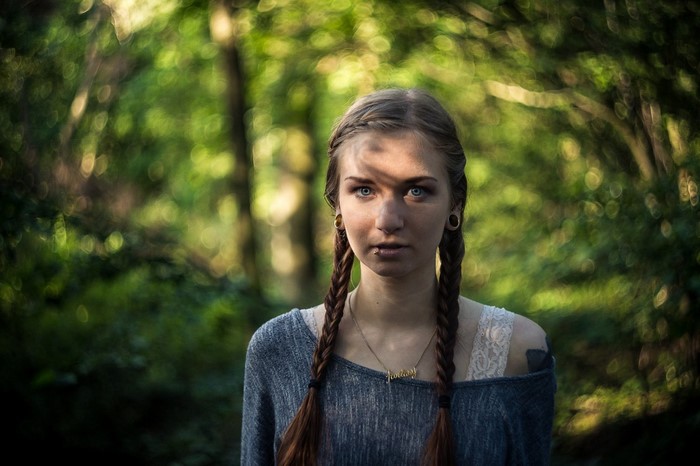 Woman with braids in a forest
