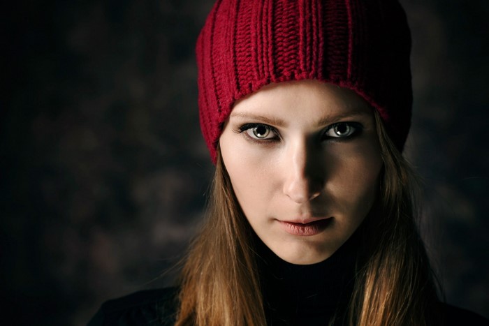 Woman in red hat and black turtleneck