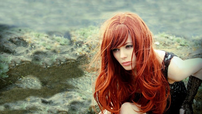 Woman with long red hair outdoors