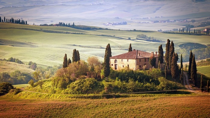 Tuscan Villa surrounded by rolling hills and cypress trees