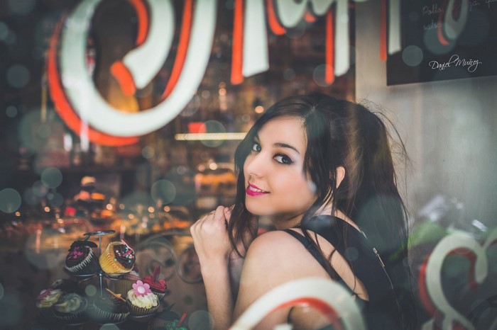 Young woman looking back at the camera in a bakery