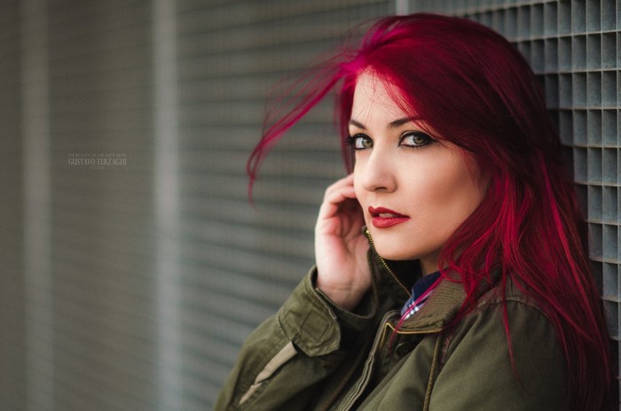 Woman with vibrant red hair and green eyes