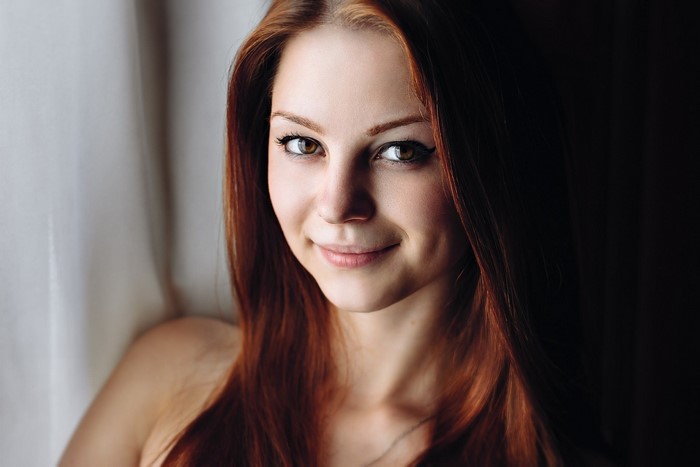 Portrait of Smiling Redhead Woman with Long Hair