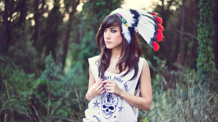 Woman wearing a headdress in a forest