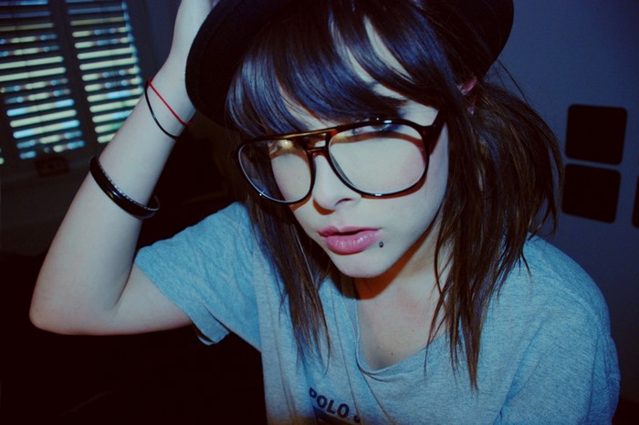 Woman wearing glasses and a hat