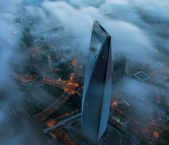 Shanghai skyscraper shrouded in clouds at night