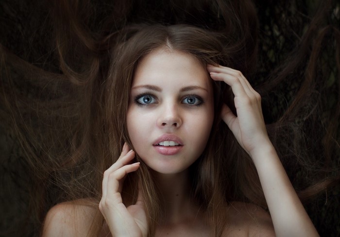Woman with long brown hair and blue eyes