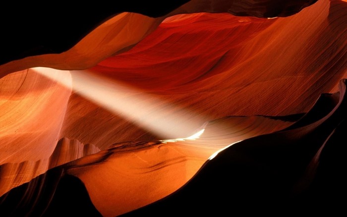 Sunlight beam in a red sandstone canyon