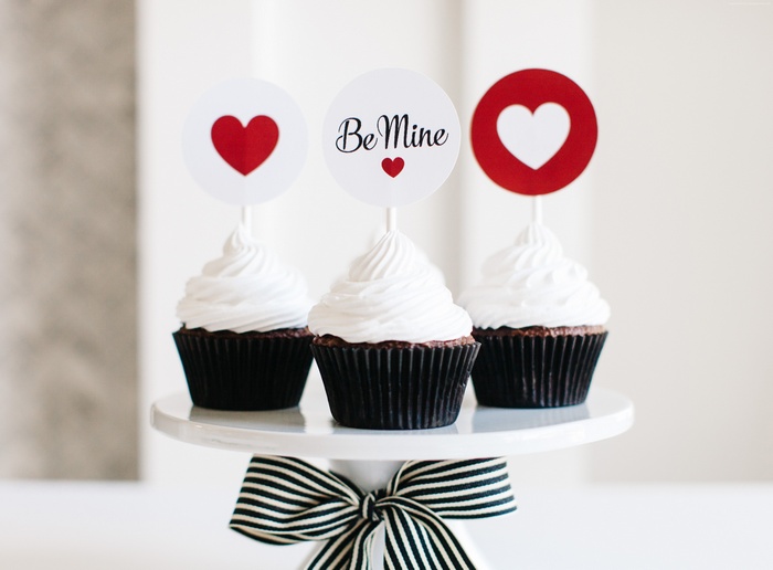 Cupcakes with Valentine's Day toppers on a cake stand