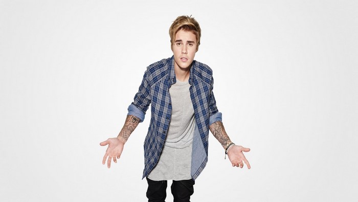 Justin Bieber in a plaid shirt and grey t-shirt