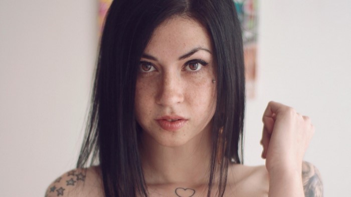 Woman with black hair and tattoos