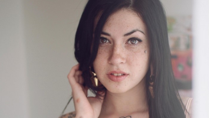 Portrait of a Freckled Woman with Black Hair