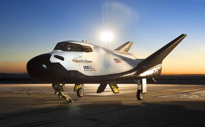 SpaceDev Dream Chaser spaceship on tarmac at sunset