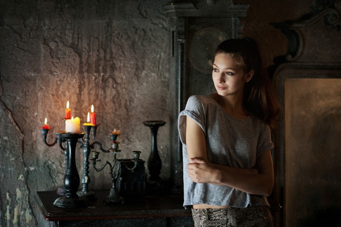 Woman in T-shirt near candles