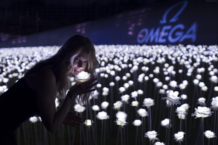 Nicole Kidman in a field of glowing roses with Omega logo