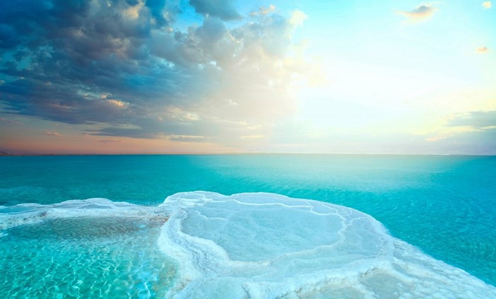 Dead Sea with salt formations and cloudy sky