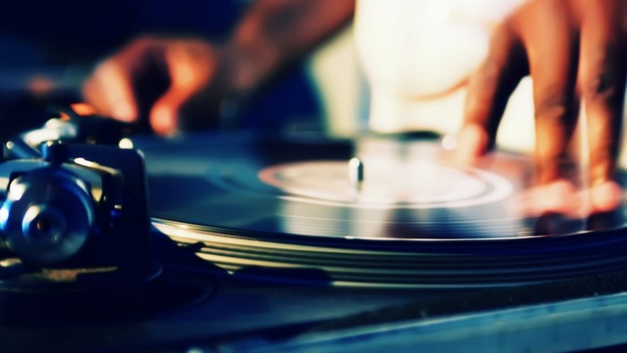 DJ scratching vinyl record on turntable
