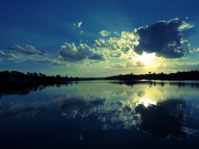 Sunset over a calm lake with reflections