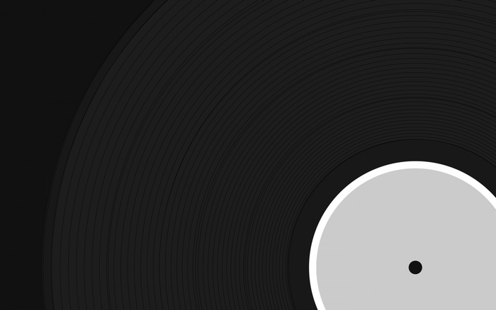 Close-up of a black vinyl record with a white label