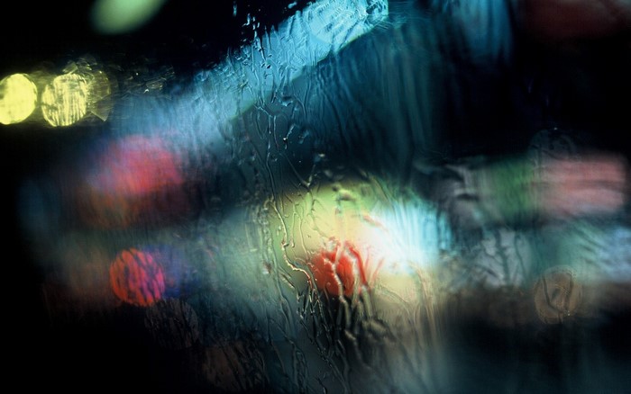 Abstract lights on wet glass at night