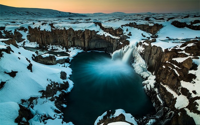 Snowy Waterfall and Lake in Iceland