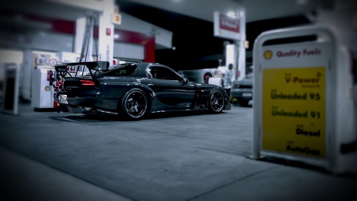 Dark Mazda RX-7 at a Shell Gas Station